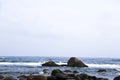 Waves and stones beneath Sanya, China Royalty Free Stock Photo